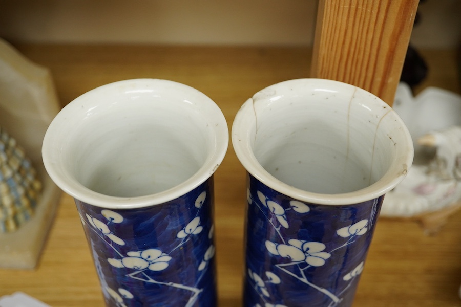 A pair of Chinese prunus flower sleeve vases, 21cm high. Condition - cracked